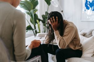 image of a distressed man talking to a professional in an office